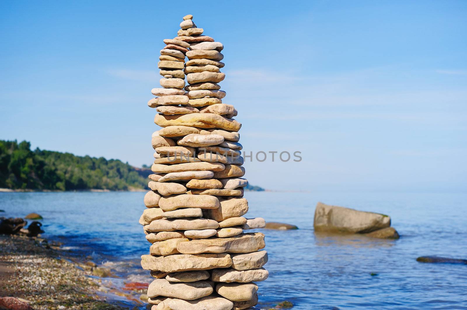 Pile of pebble as the tower on the sea coast