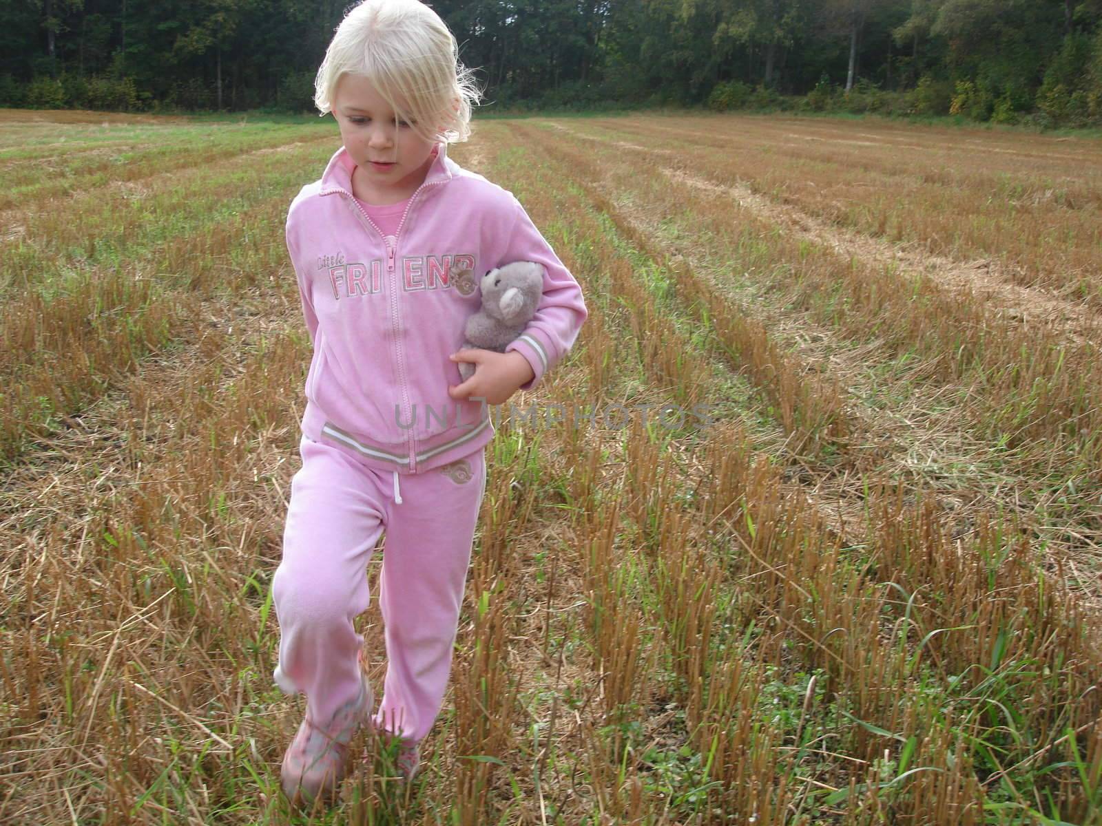 gril playing on the farm field. Please note: no negative use allowed.