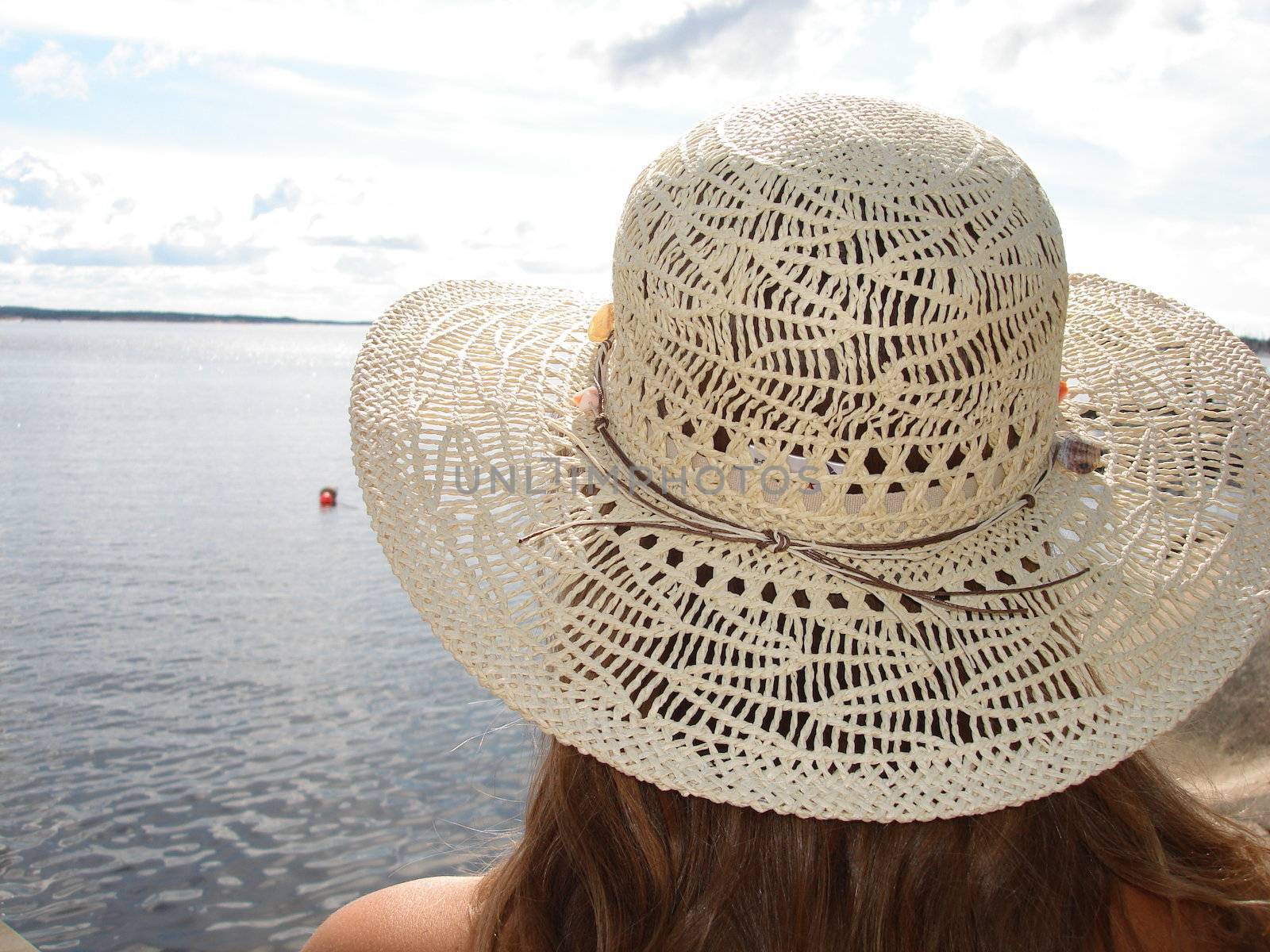 back of woman's head with hat