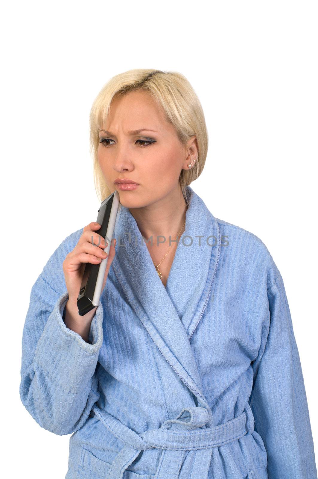 The thoughtful blonde in a dressing gown with the panel from the TV it is isolated on a white background.