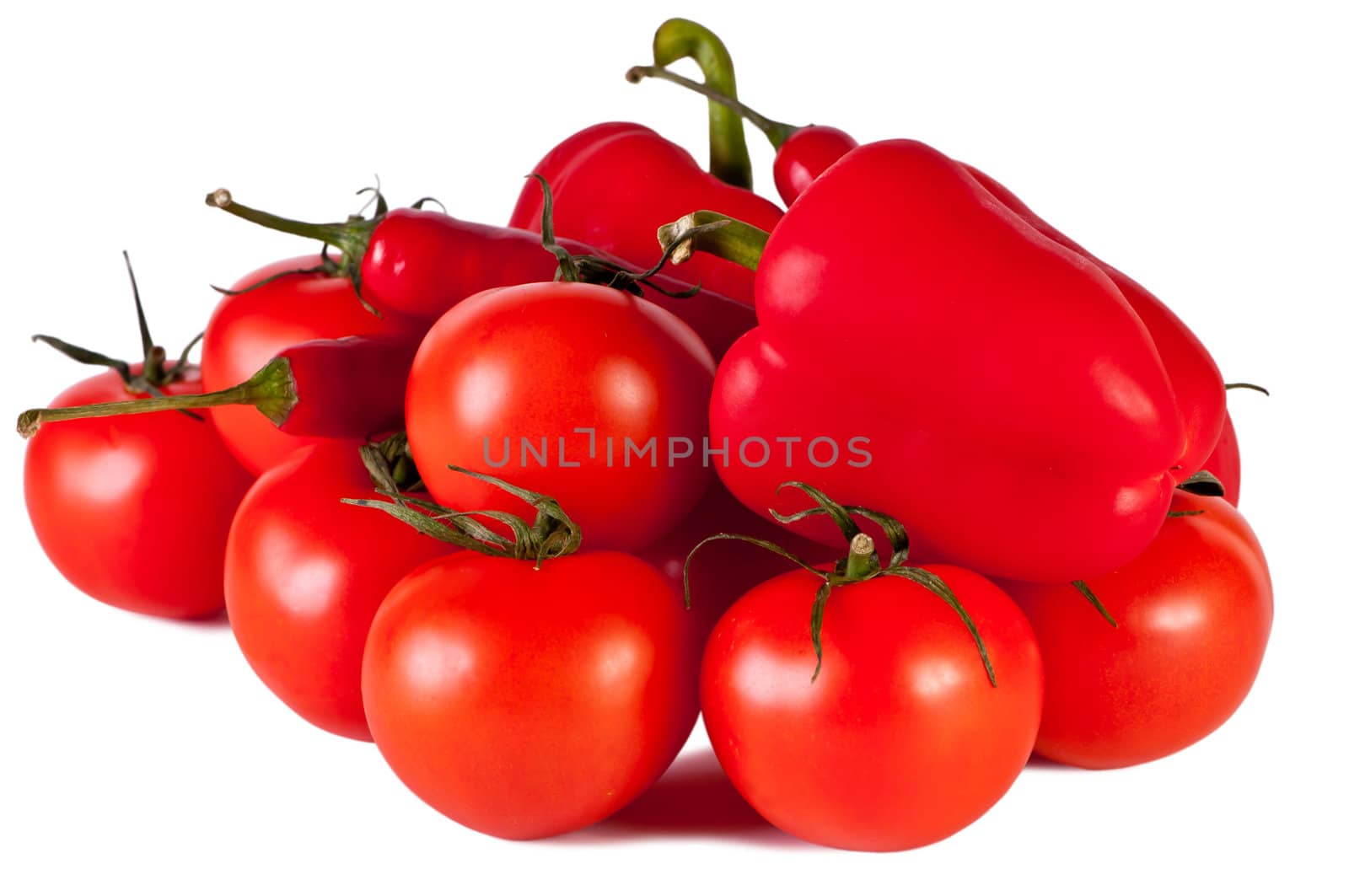 Peppers, tomatoes, lie on the white table. Vegetables on a white background.