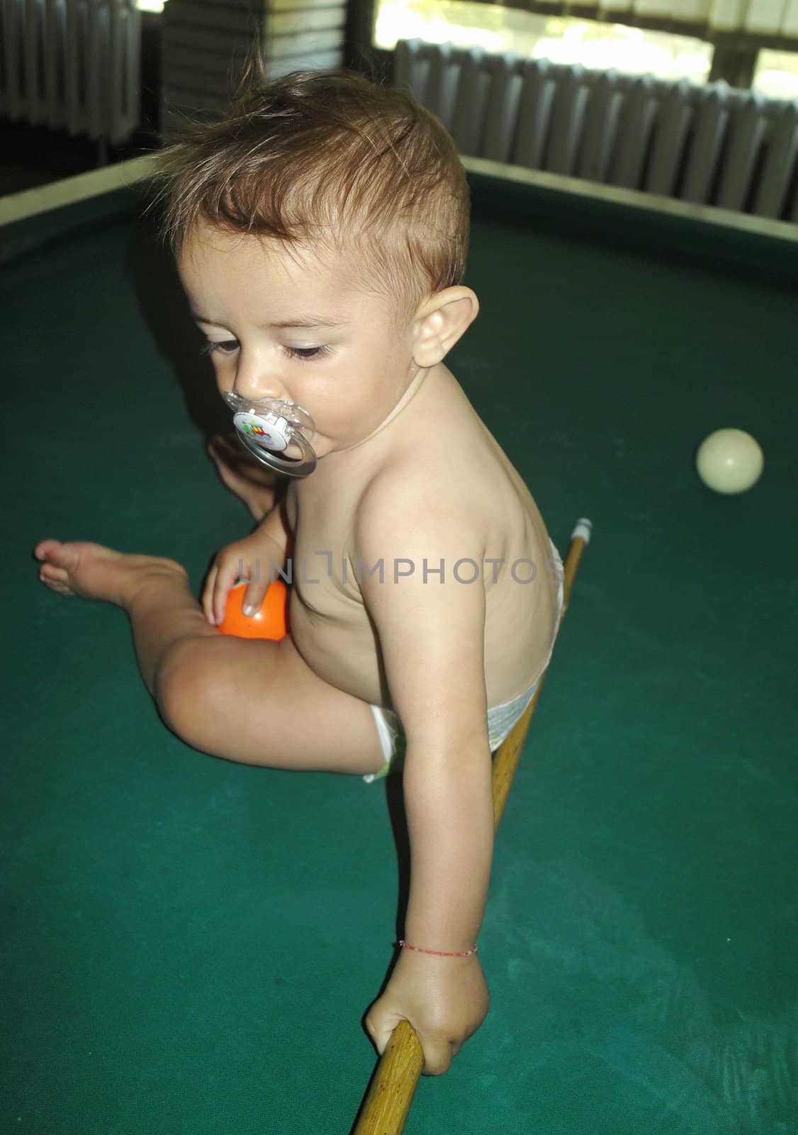 Little boy playing snooker