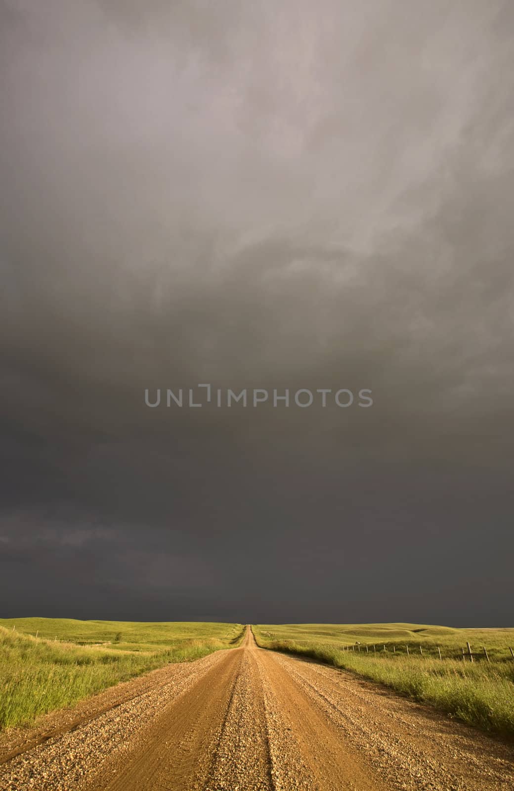 Storm clouds over Saskatchewan country road by pictureguy