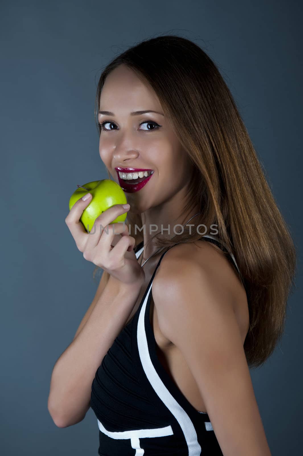 Attractive model with an apple in a hand