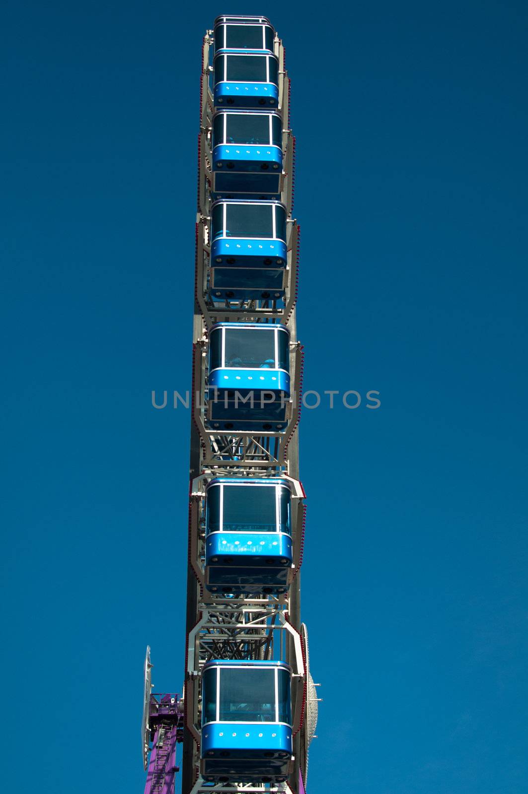 ferris wheel at amusement park against great blue sky