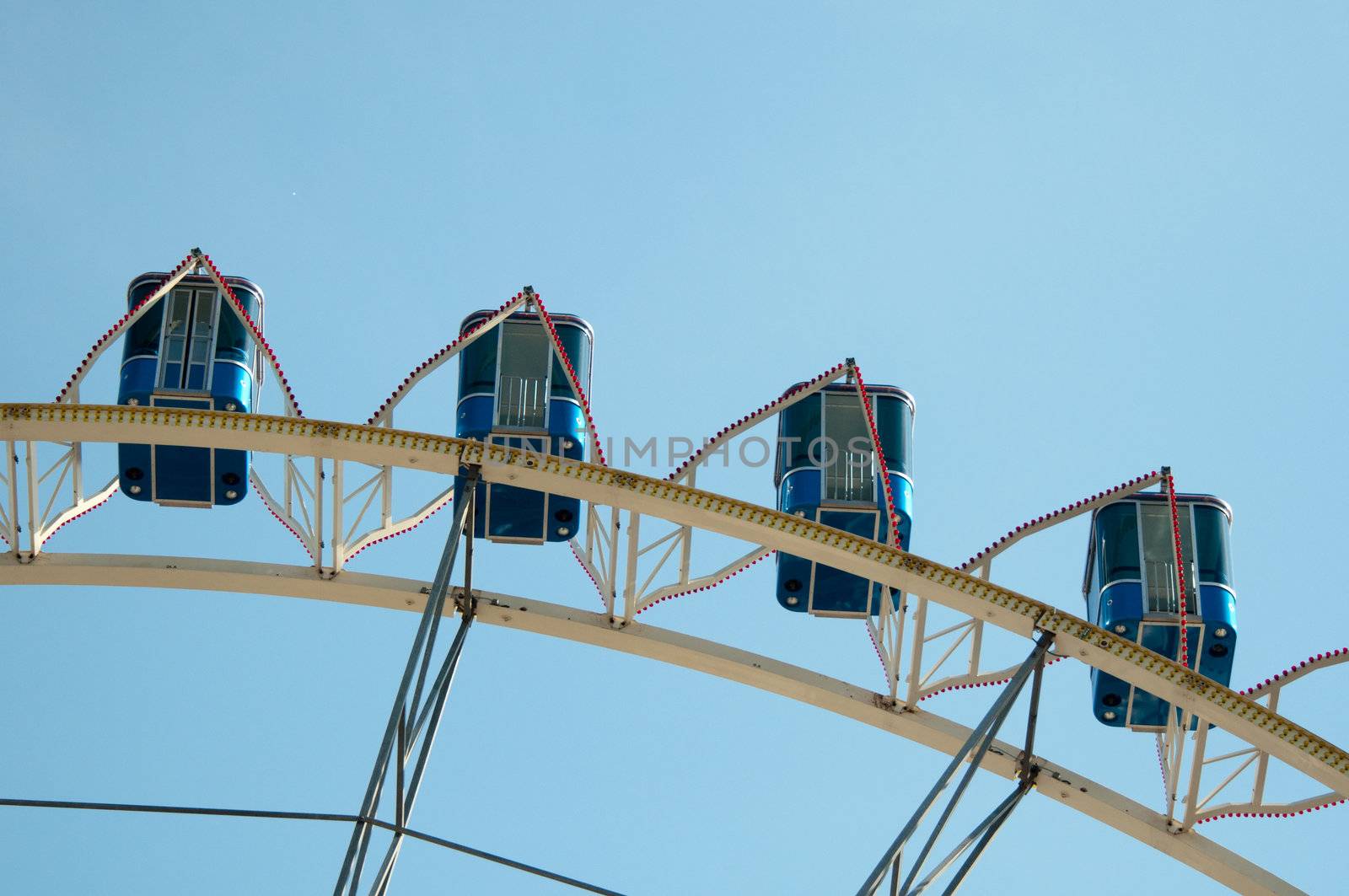 ferris wheel at amusement park against great blue sky