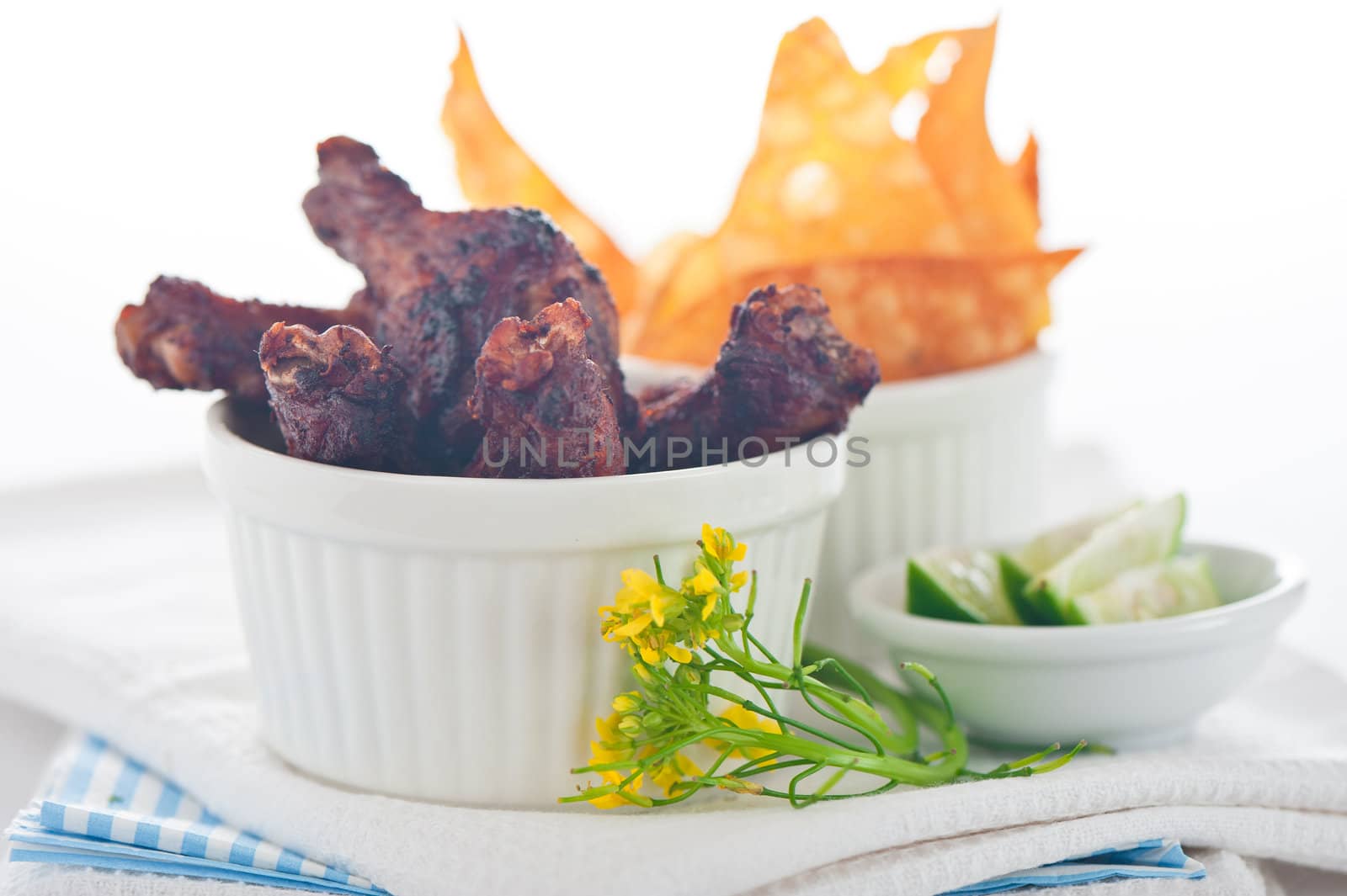 chicken legs with chips on a white background