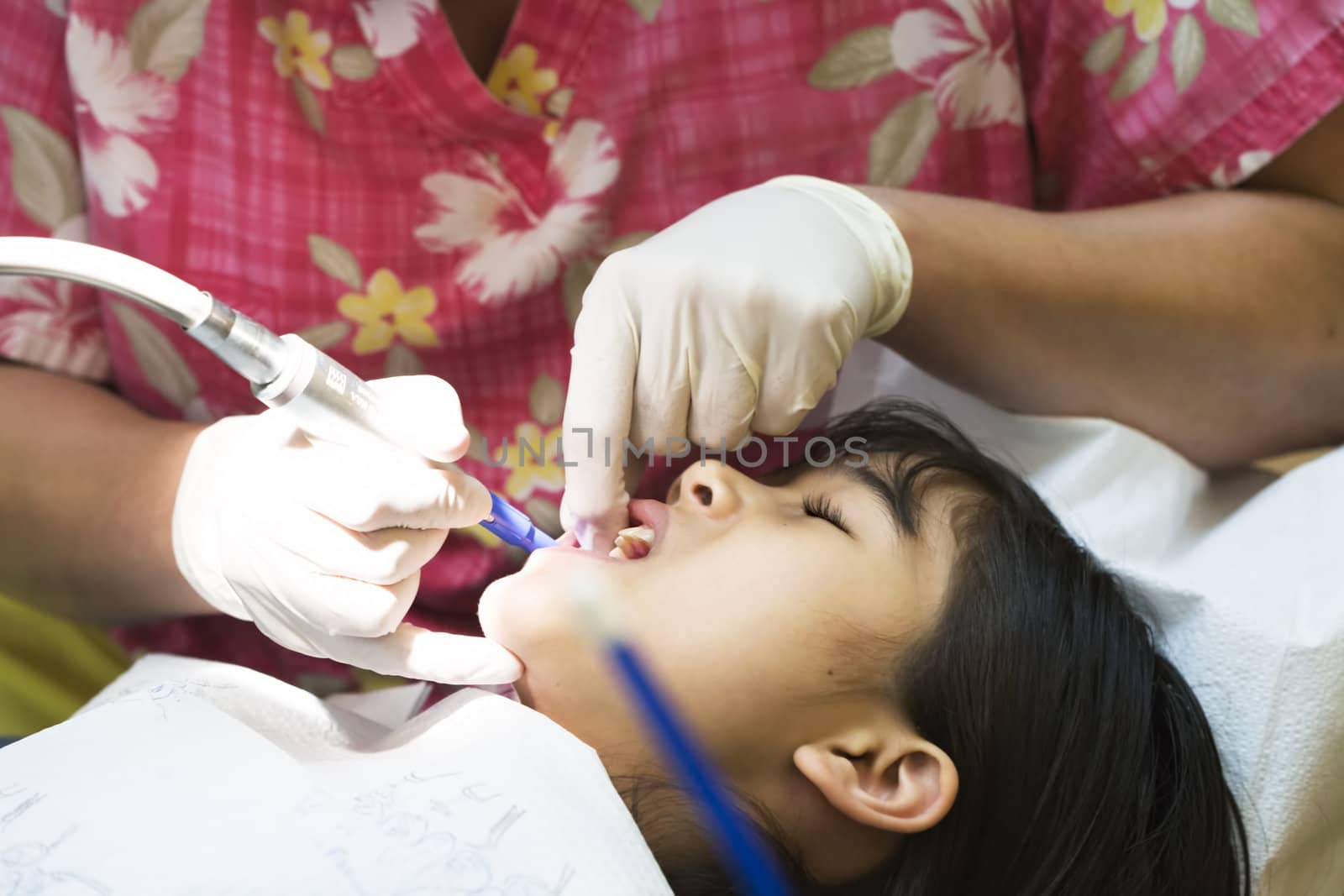 Little girl having teeth cleaned at dental office