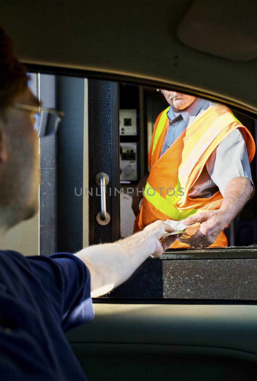 Man paying money at toll booth