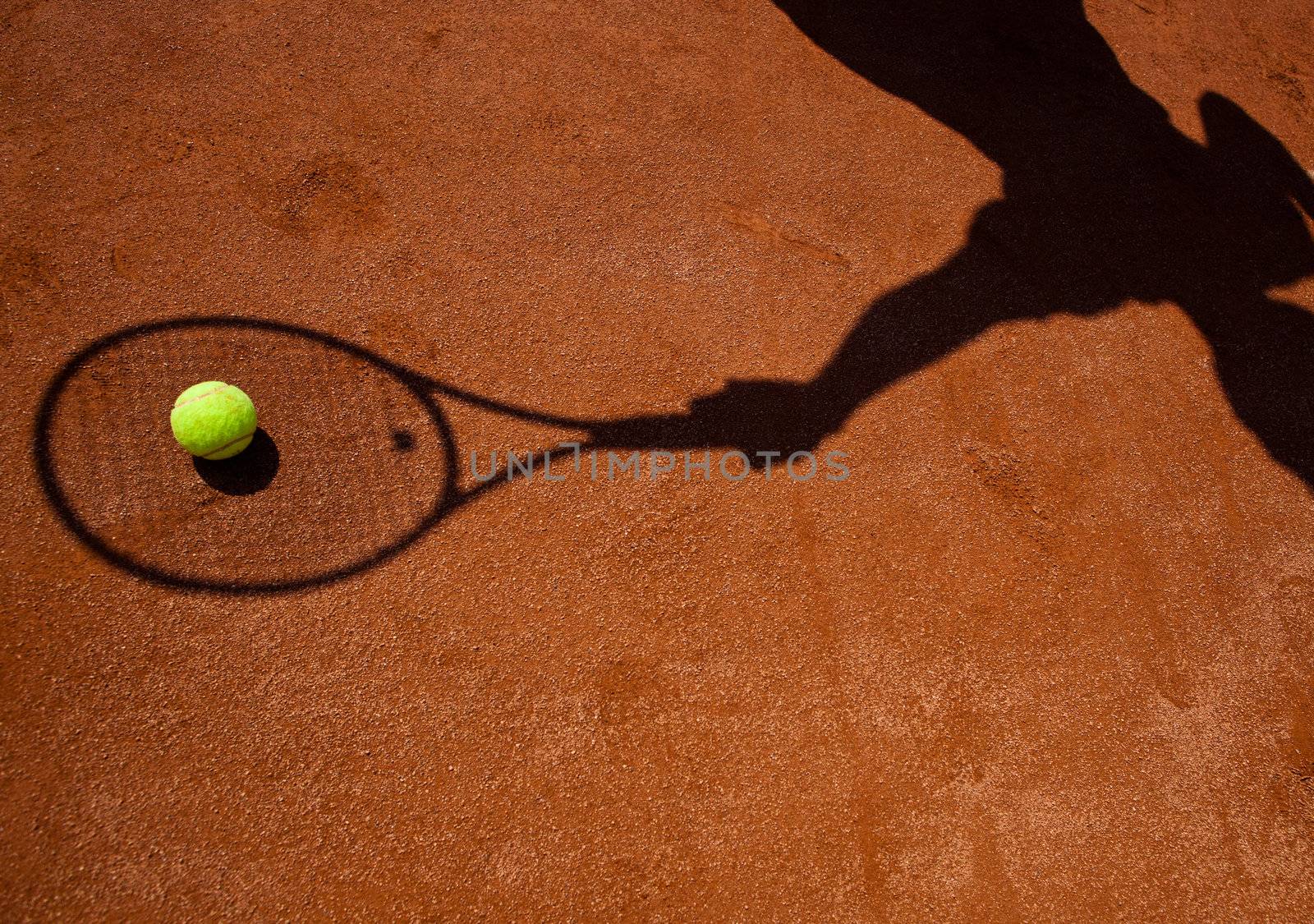 shadow of a tennis player in action on a tennis court