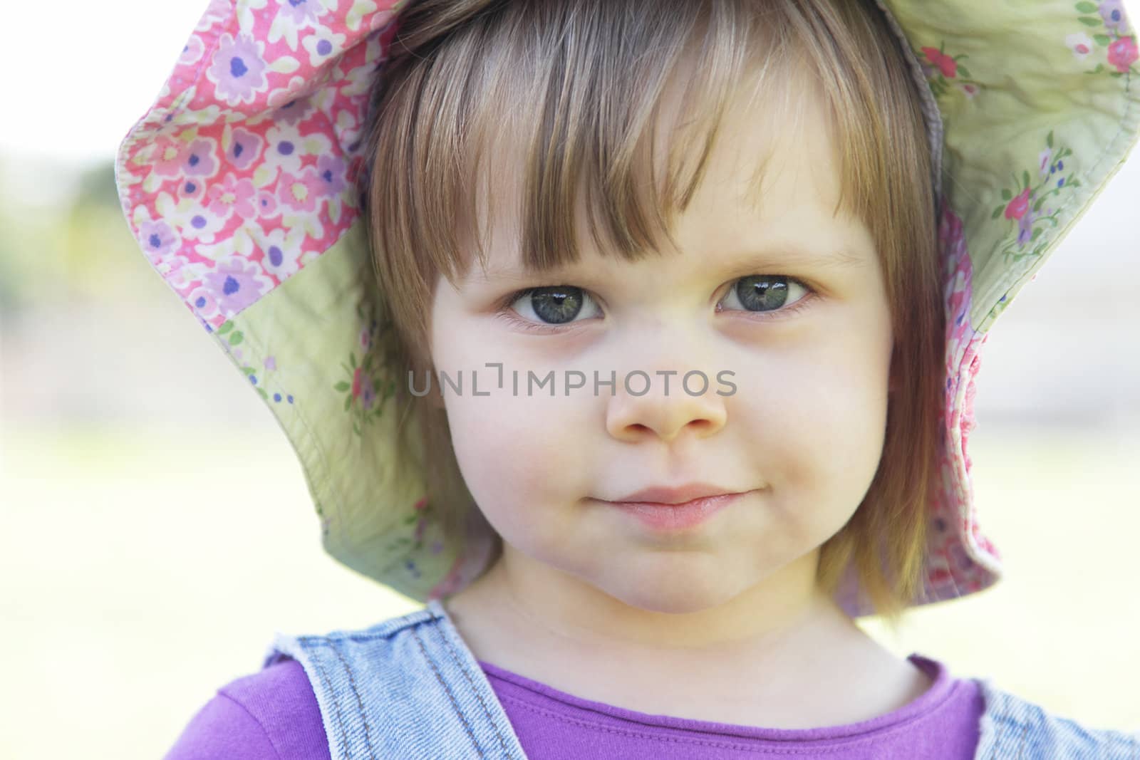 Cute little girl with a hat outdoors