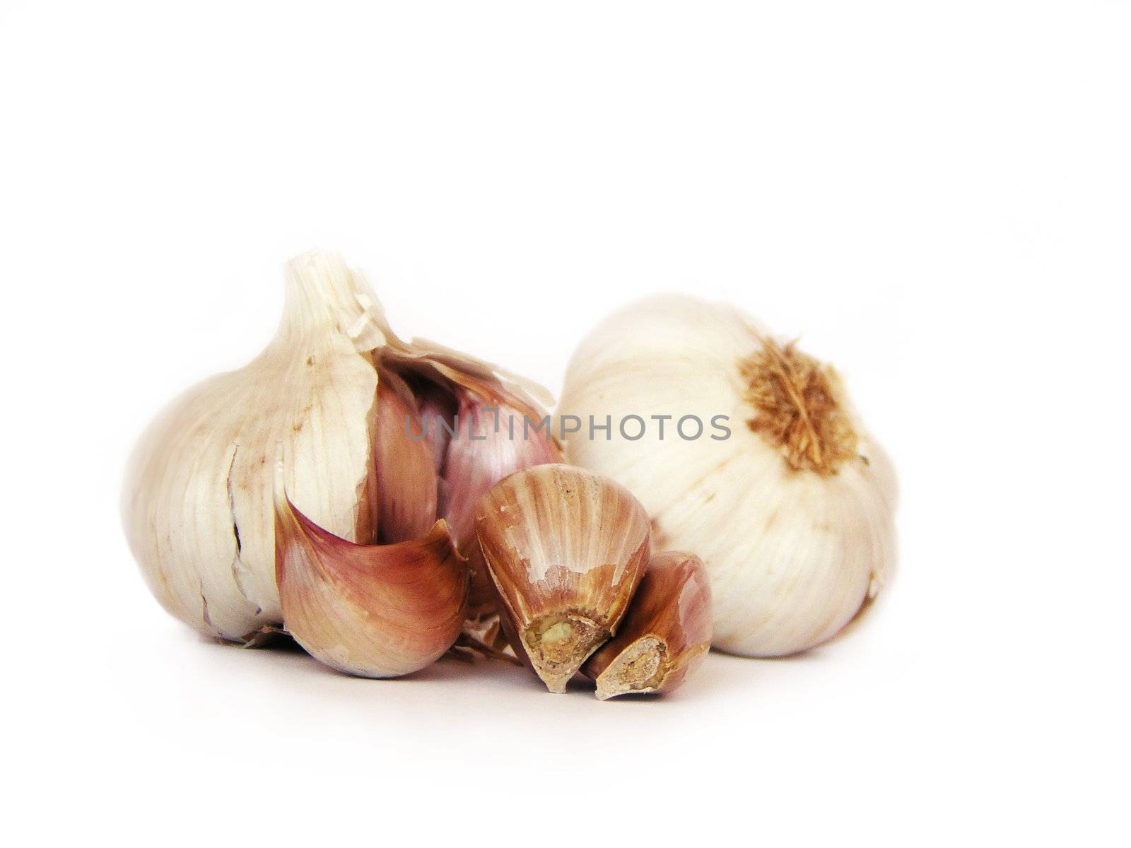 Clove of garlic, with garlics on the background