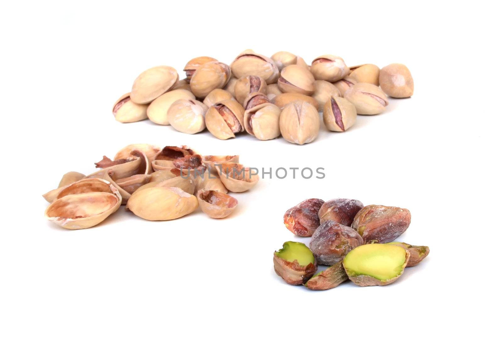 Close up of pistachios on white background