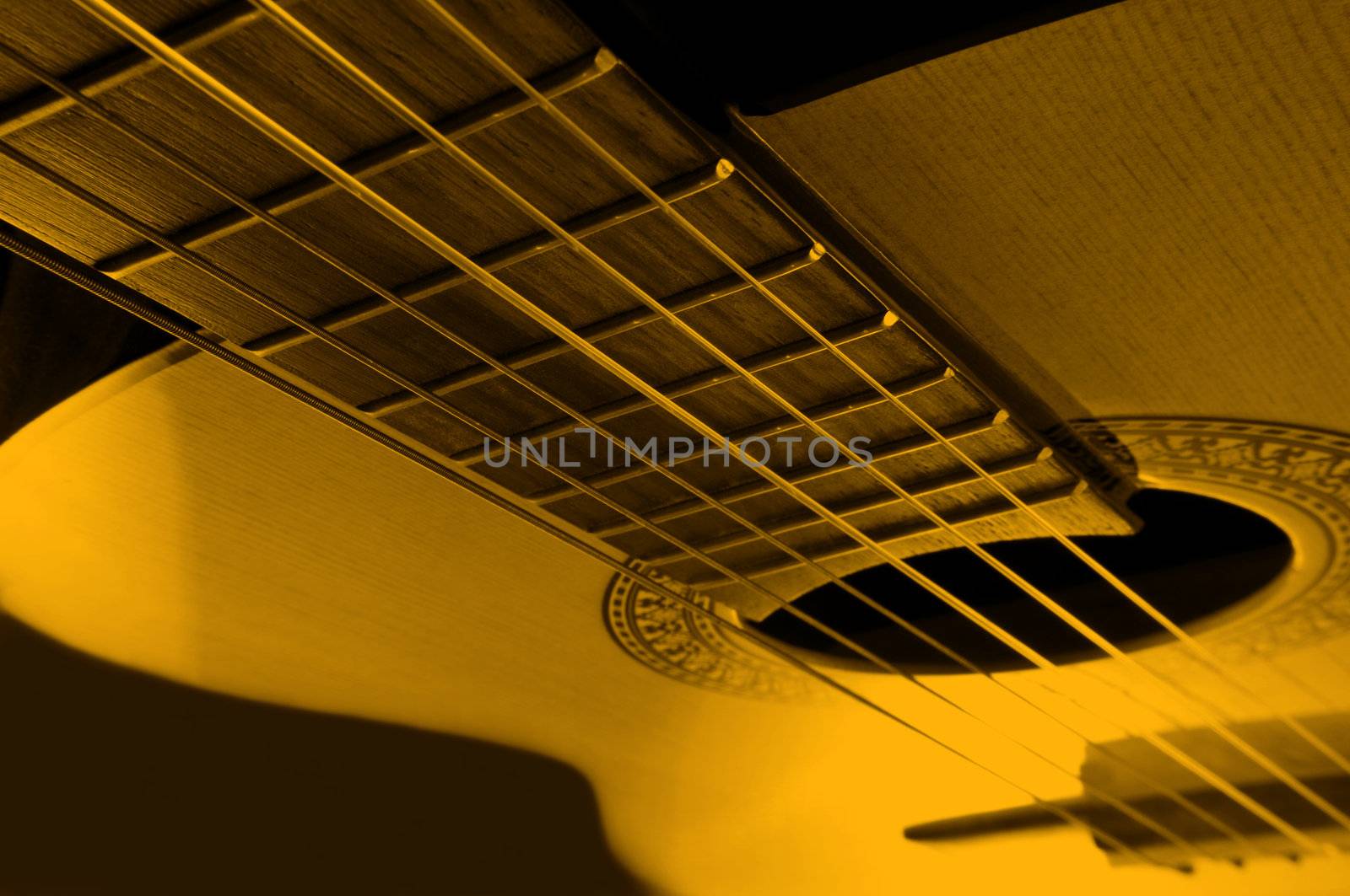 Acoustic guitar with yellow light effect.