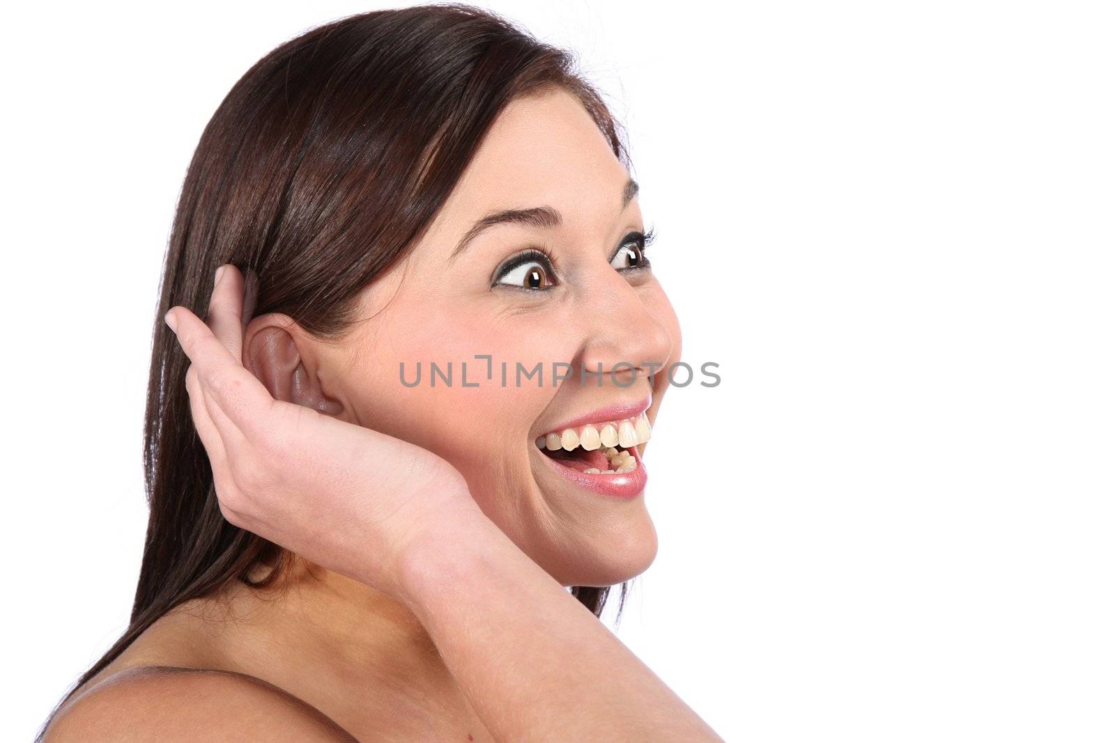 Lovely brunette woman with excited expression and hand cupped to her ear