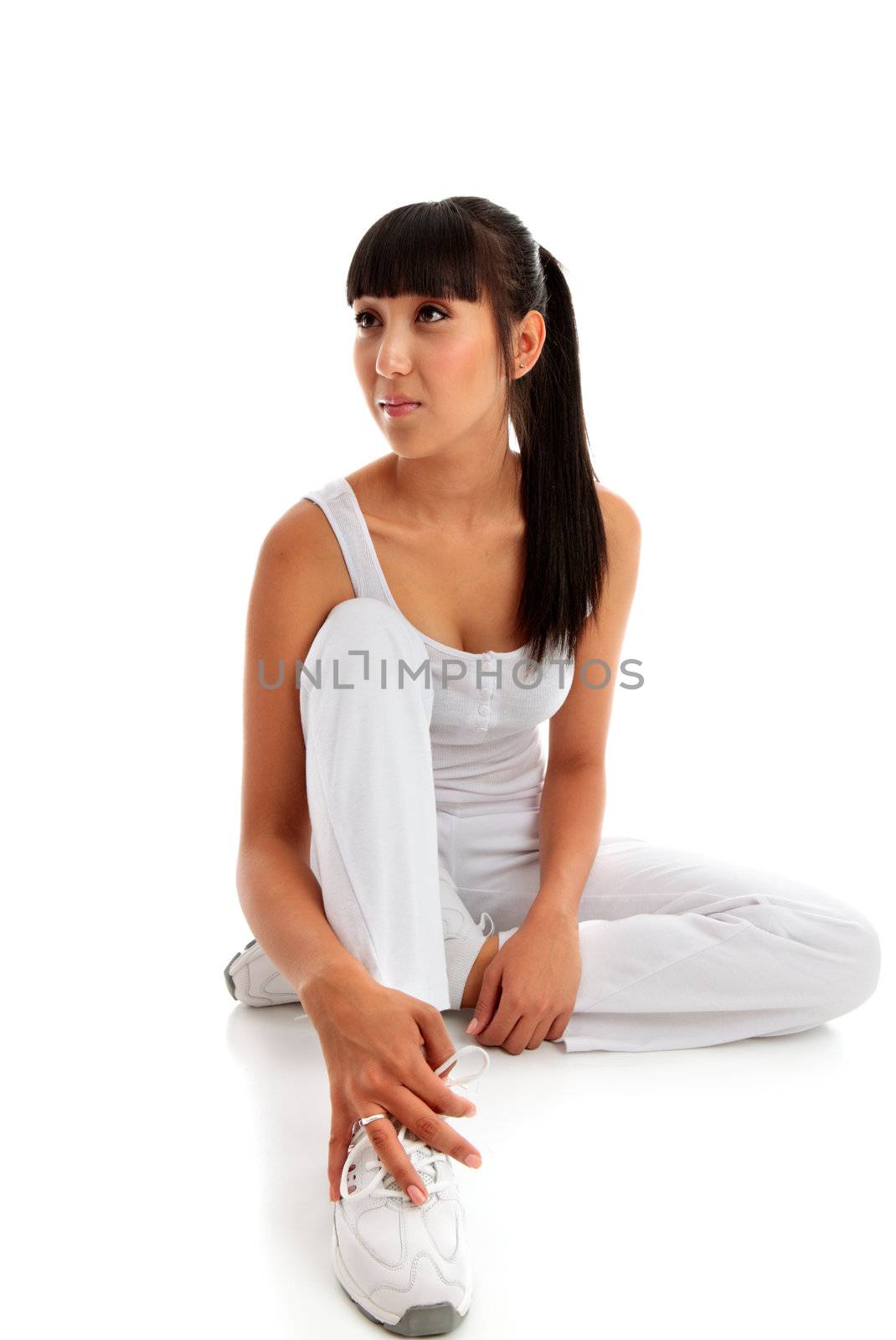 A young beautiful woman wearing fitness clothing and sitting on a white background.  She is looking sideways.  Pretty mixed race girl asian caucasian.  Space for copy.  
Model Jessica Elms, Makeup Hanae Satomura, Hair by Kayla Cifelli