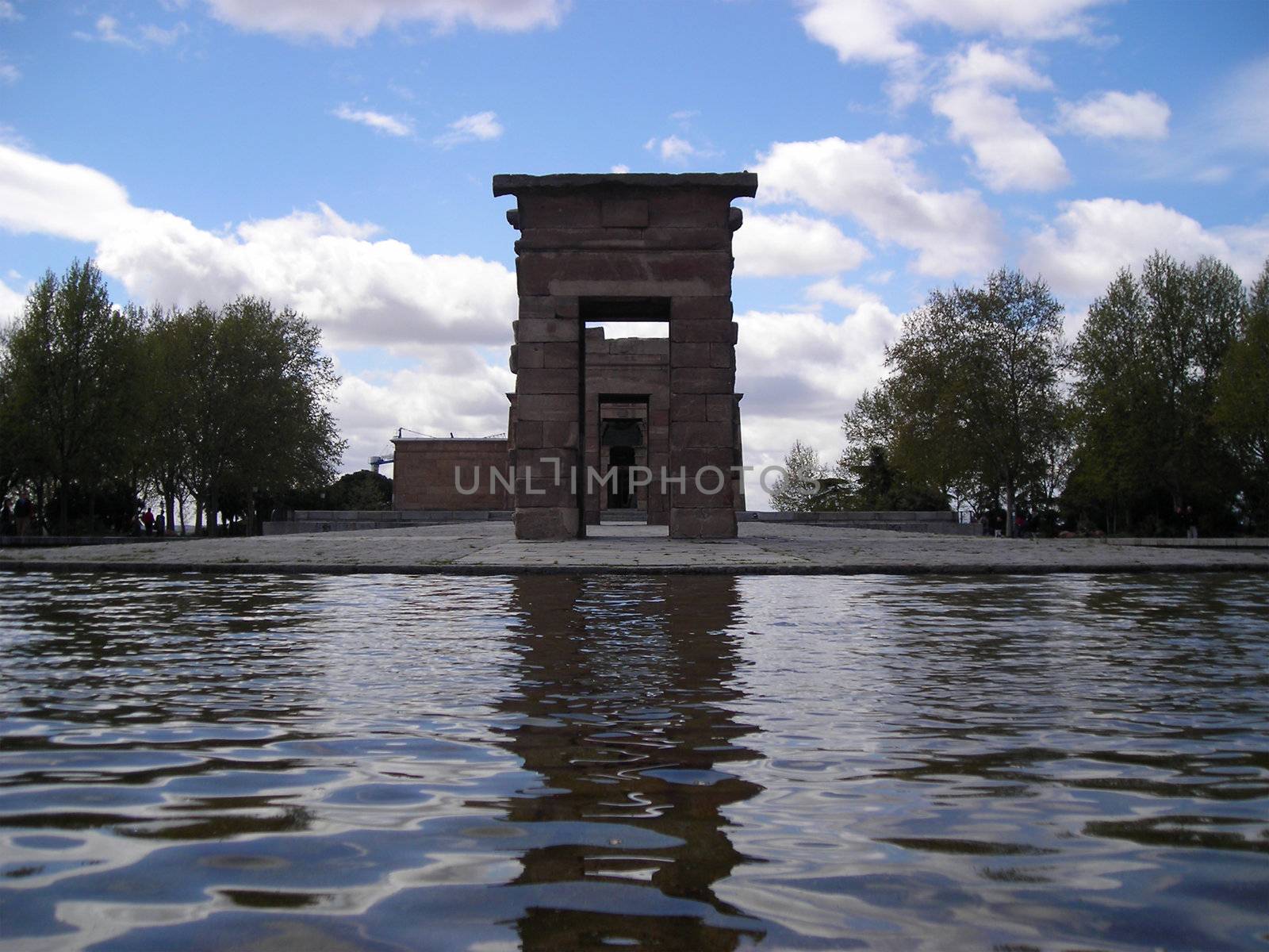 View of the Debod Temple in Madrid surrounded by a pond and trees, a gift from egiptian king to Juan Carlos I, King of Spain.