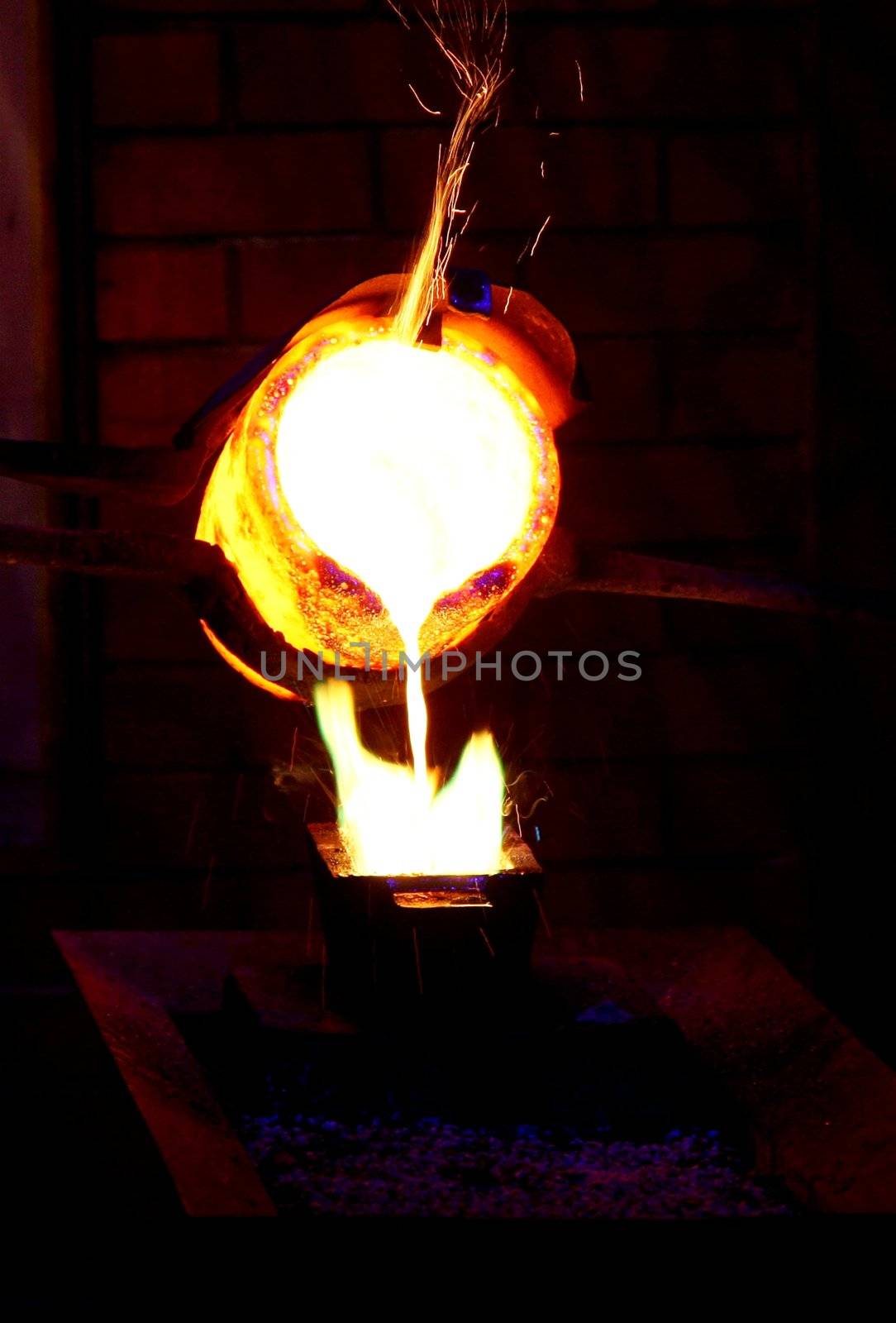 Molten gold being poured to form an ingot bar