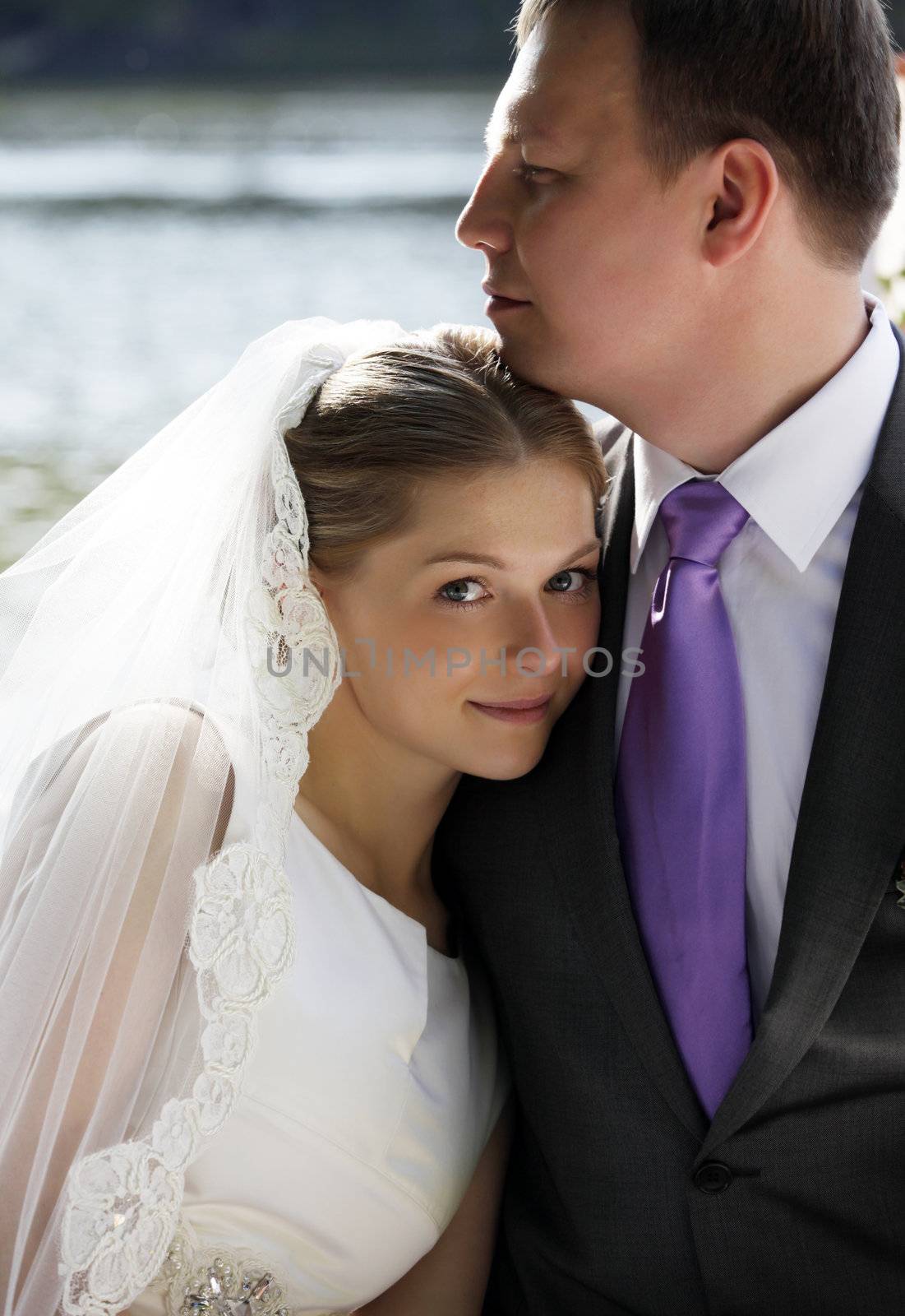 Happy newly-married couple in park