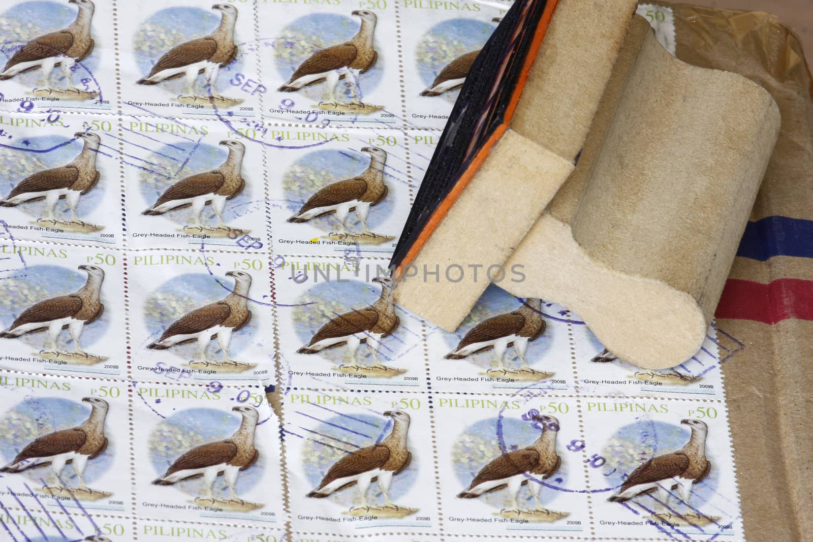 Manila cancel stamps in a box with ink stamp.