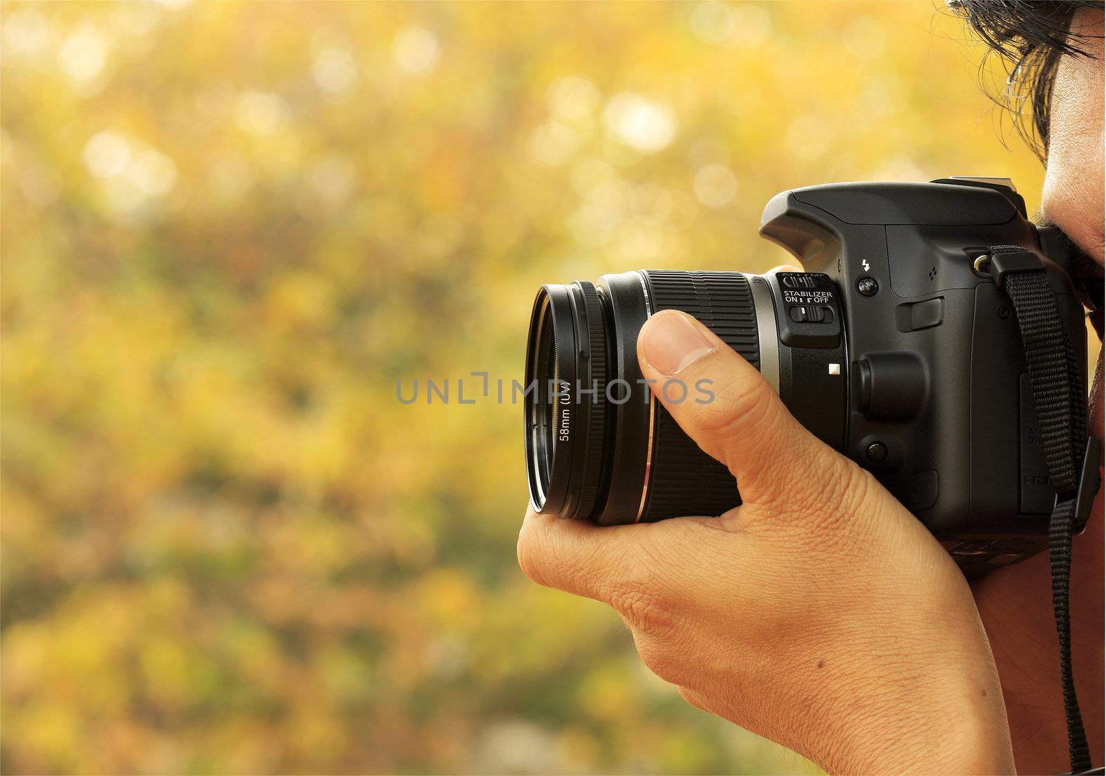 Photographer Taking A Shoot With A Digital Camera And A zoom Lens
