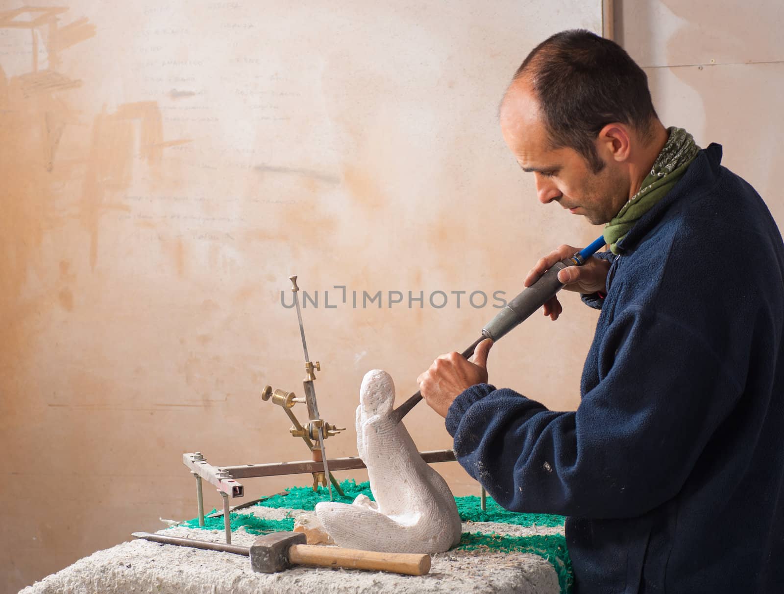 Sculptor working on his art at his workshop