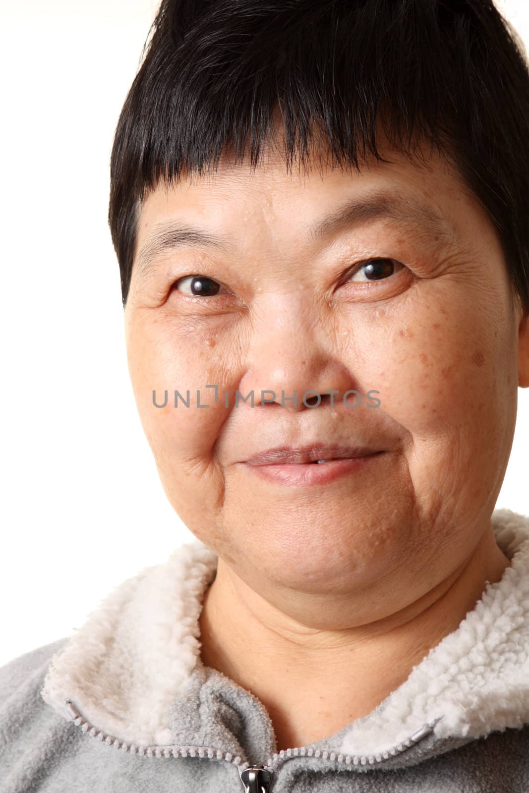 Studio Portrait Of Smiling Senior Woman  by cozyta