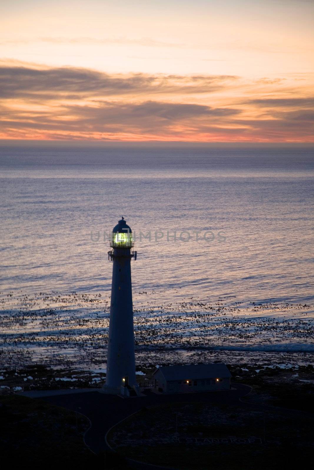 Lighthouse in the sea at simons town during a beautiful sunset