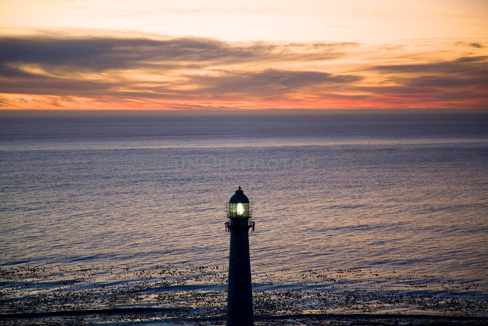 Lighthouse in the sea at simons town during a beautiful sunset