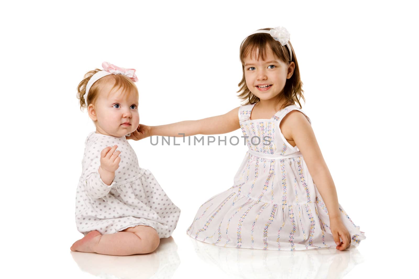 Two little Sisters playing together isolated on white