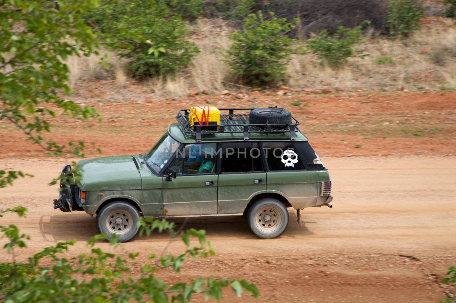 Offroad in Namibia with green car and red desert - Kaokoland