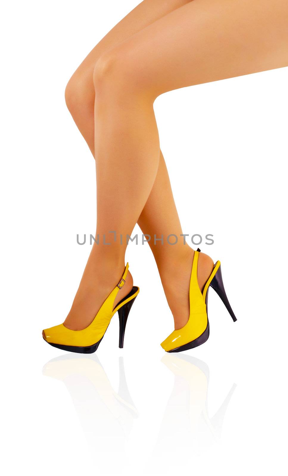Beautiful legs of young girl in tights and yellow shoes isolated on white background