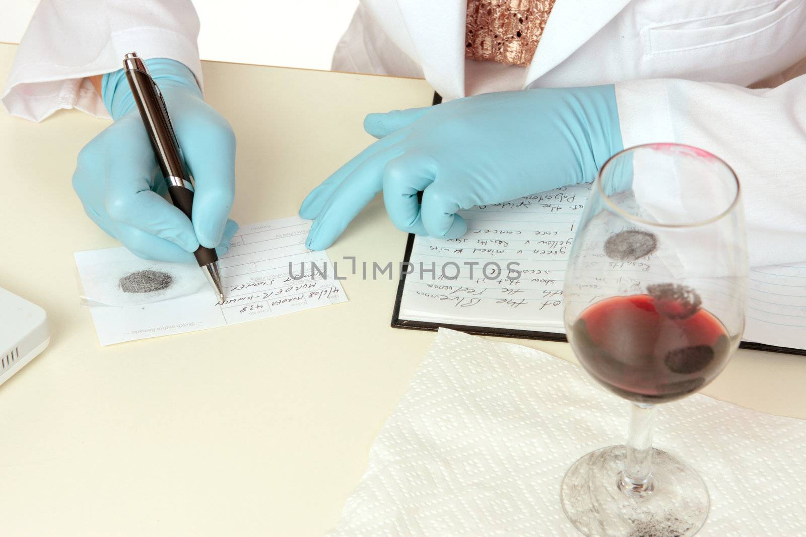 A crime scene forensic scientist obtains fingerprints from a glass using latent powder and tape and then writes down details.  Details are fictitious.