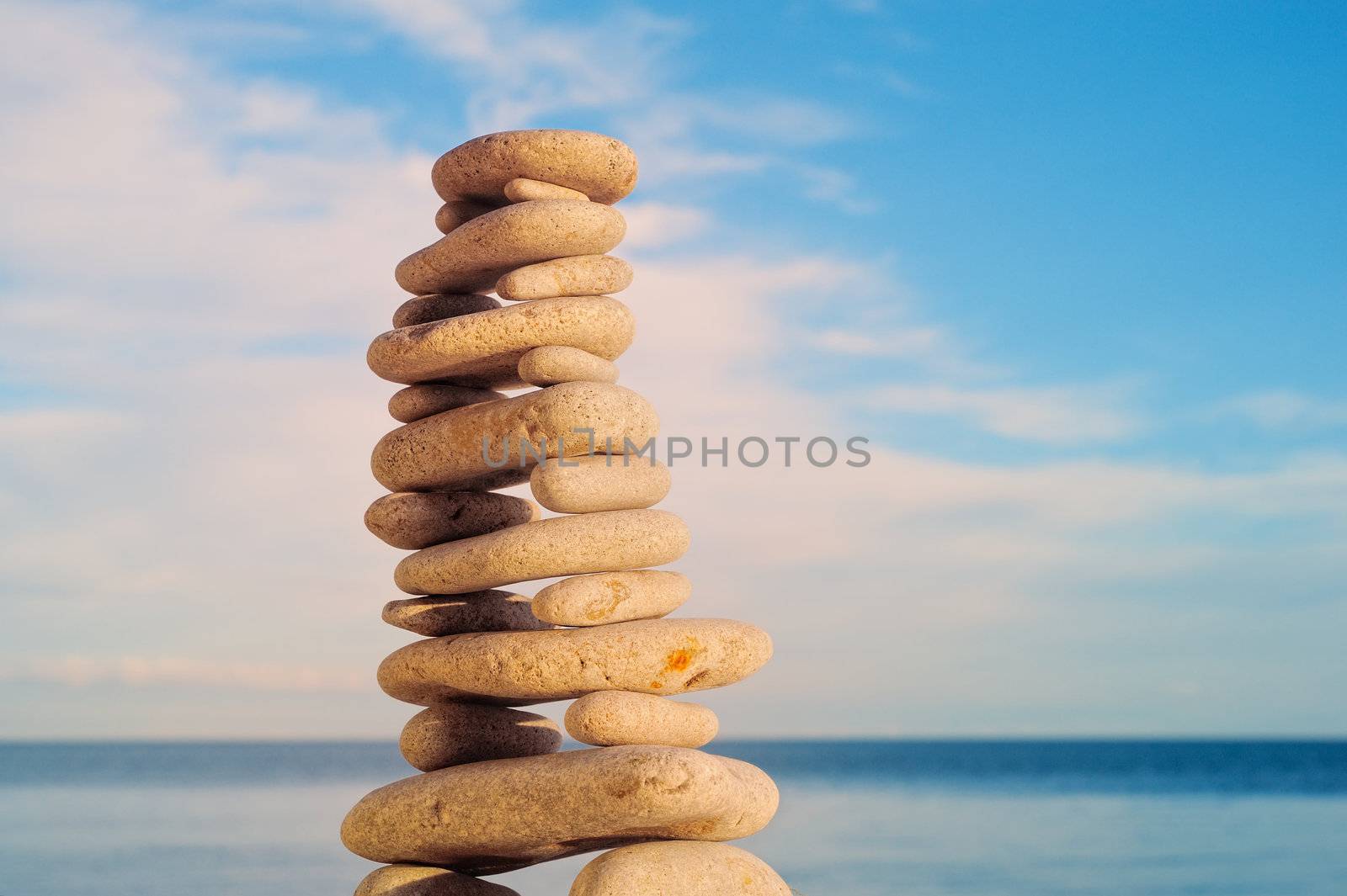 Stack of zen stones on a sky and sea background