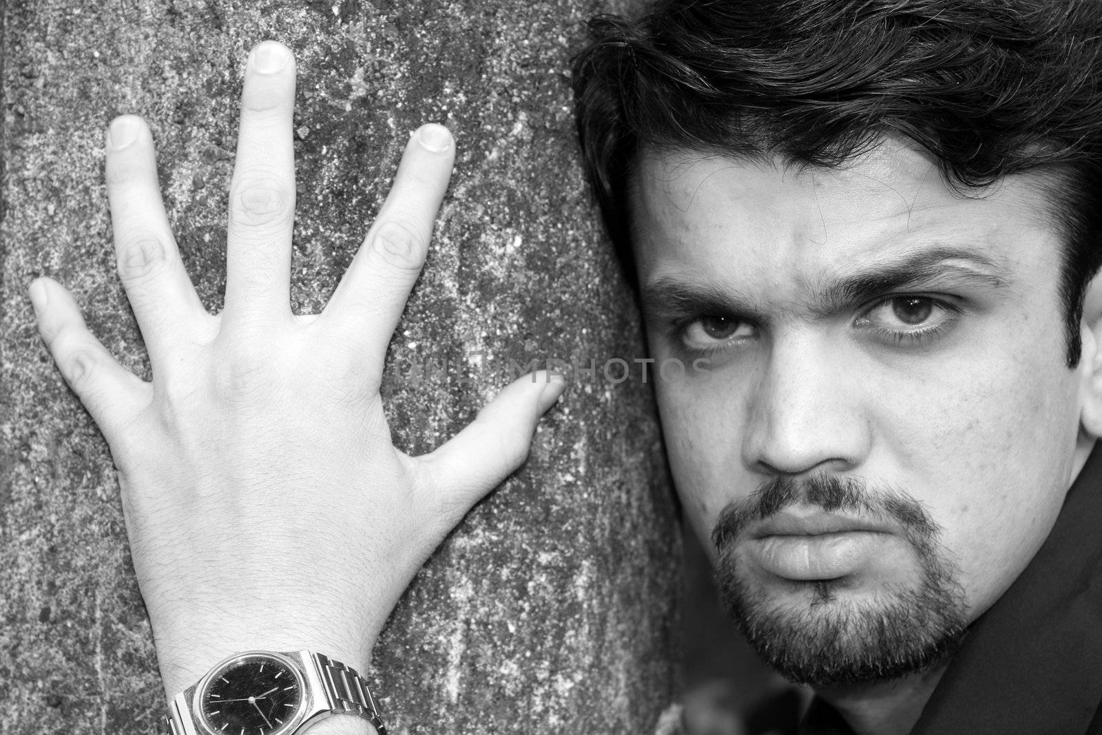 A black & white portrait of a handsome young Indian man.