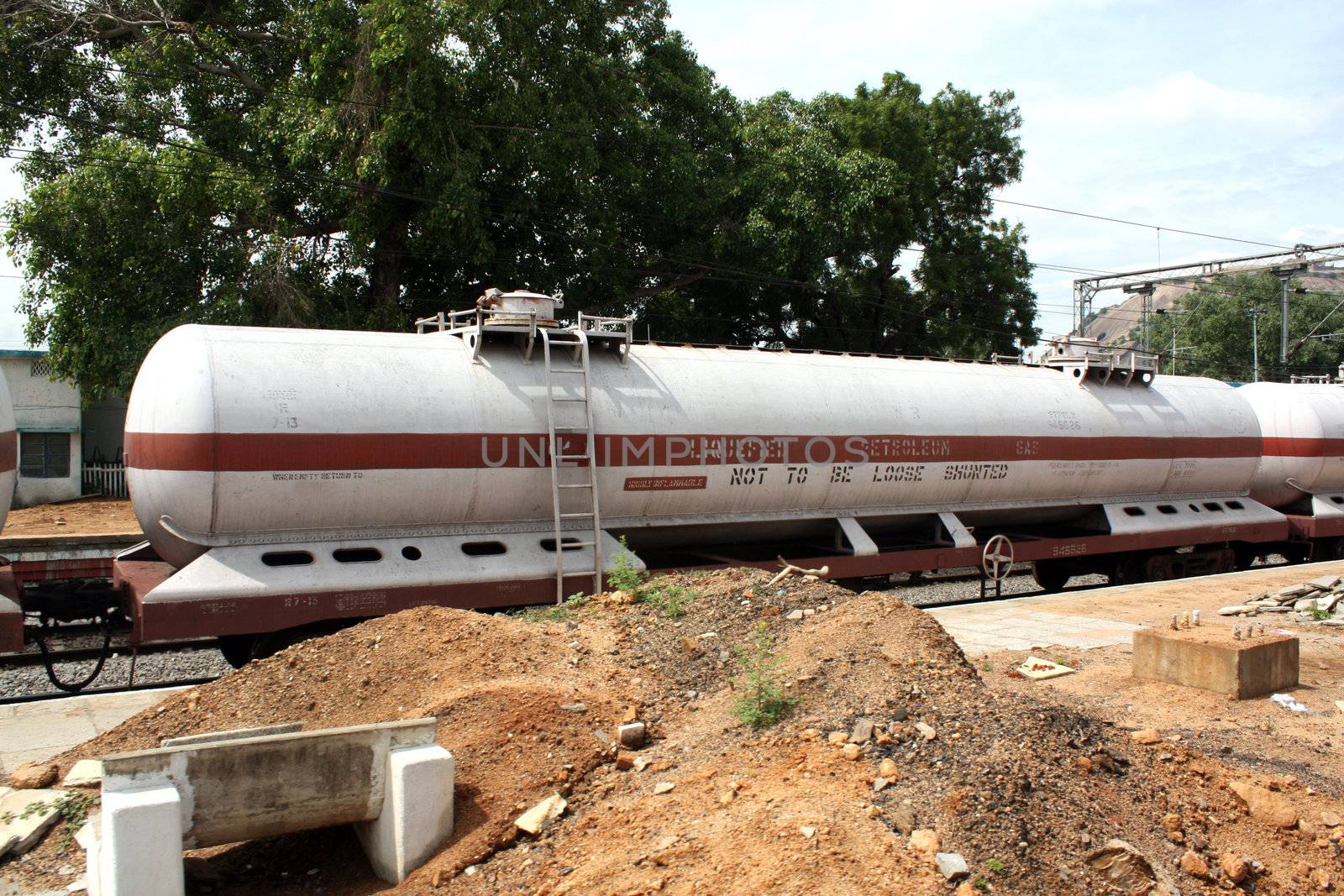 A huge railway carriage containing a petroleum tanker