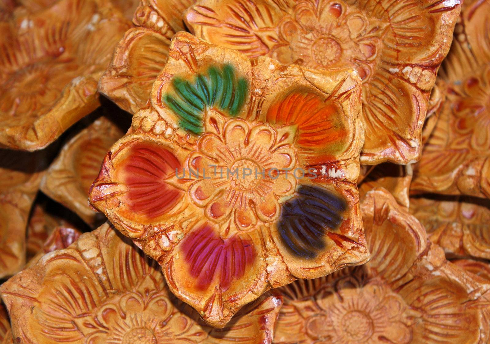 A traditional lamp painted with traditional colors during the holi festival in India.