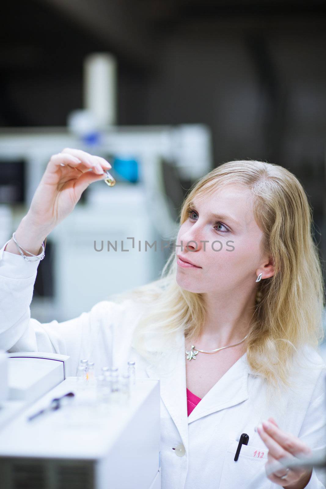 portrait of a female researcher carrying out research in a chemistry lab (color toned image; shallow DOF)