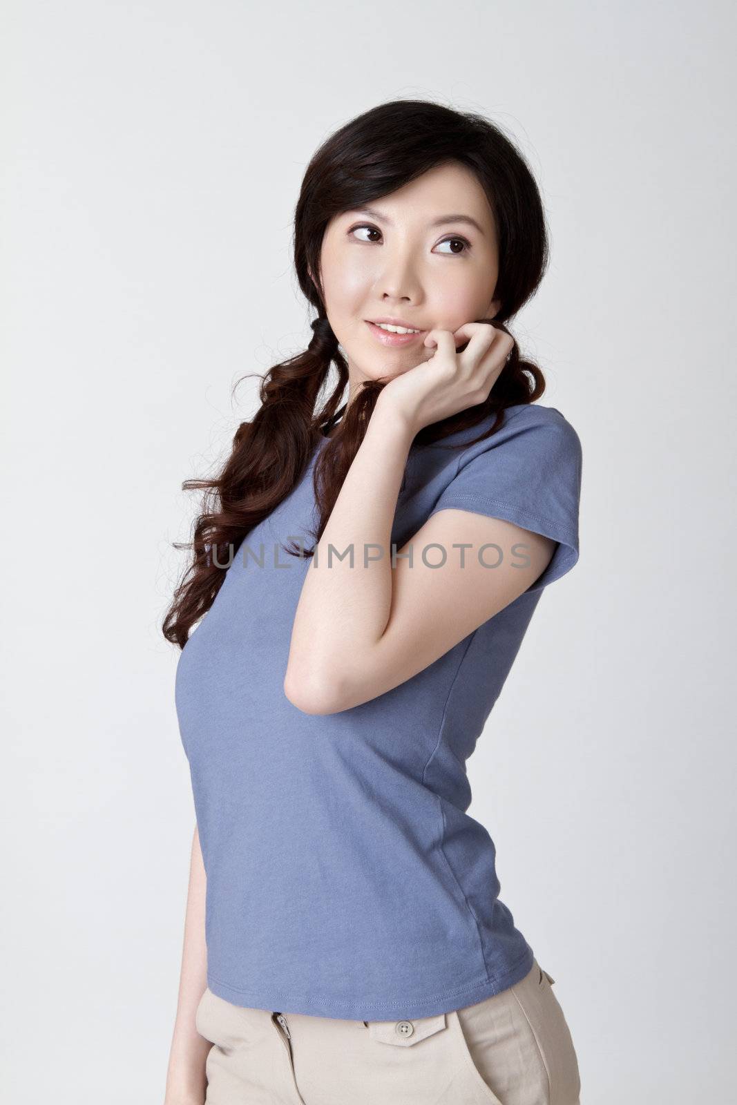 Cute Asian beauty, closeup portrait on gray background.