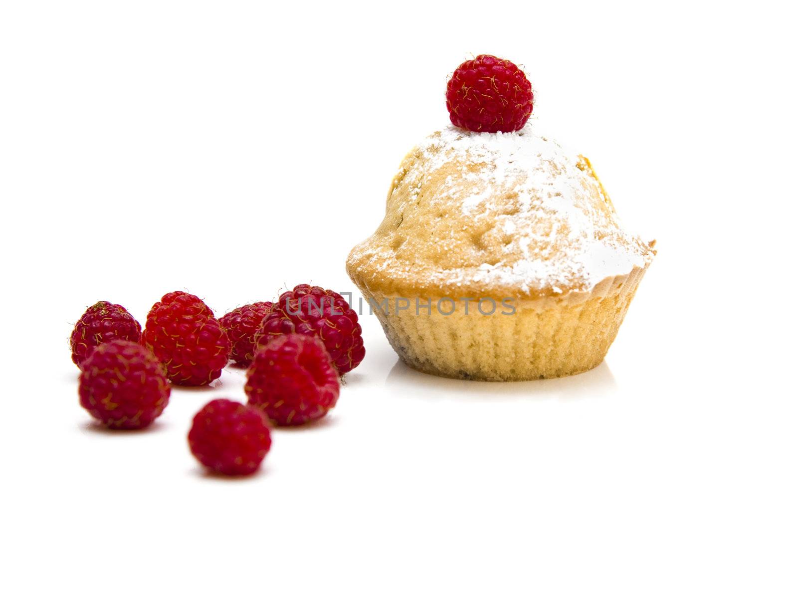 Muffins with raspberries isolated over a white background