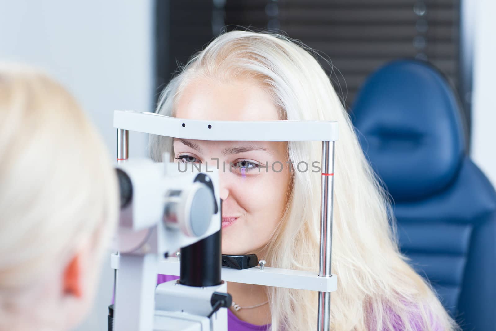 optometry concept - pretty, young female patient having her eyes by viktor_cap