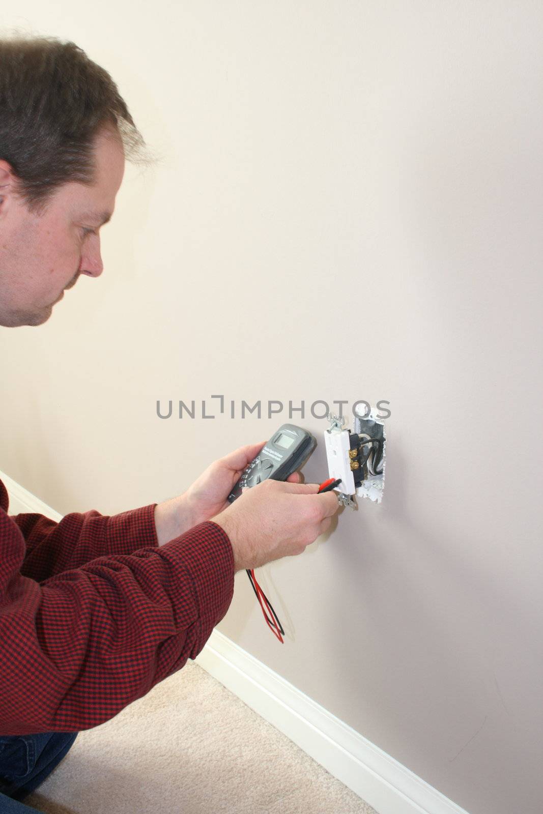 professional electrician testing 120v electrical outlet