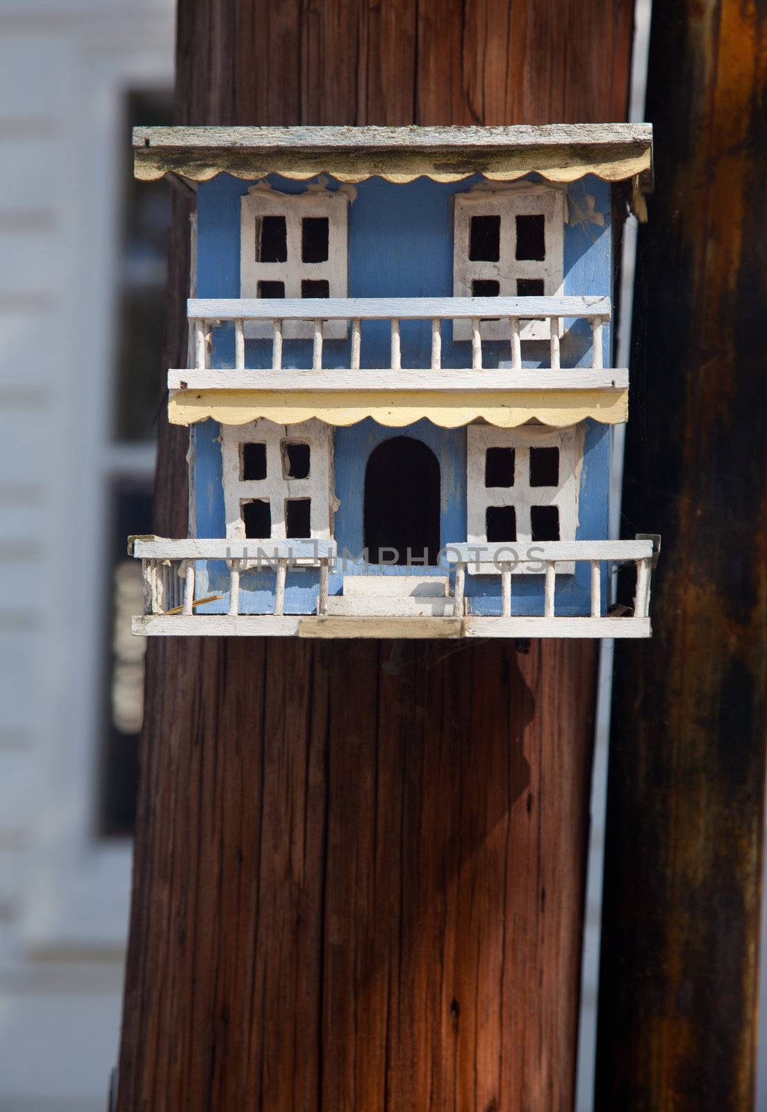 Ornate hand made blue painted bird house made to look like an old mansion