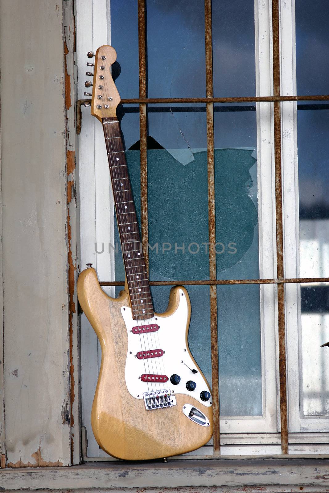 the old wooden guitar in the window