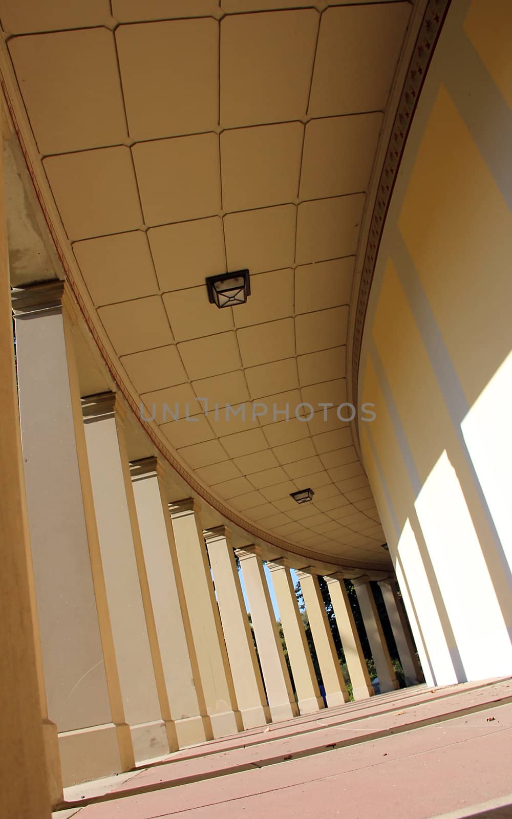 bright corridor with old pillars and shadows