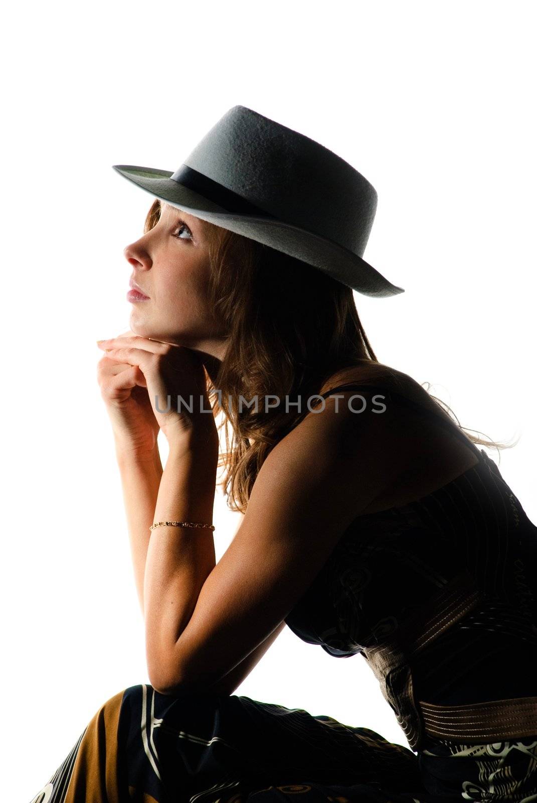 Studio shot of young beautiful woman with white hat. Backlight.
