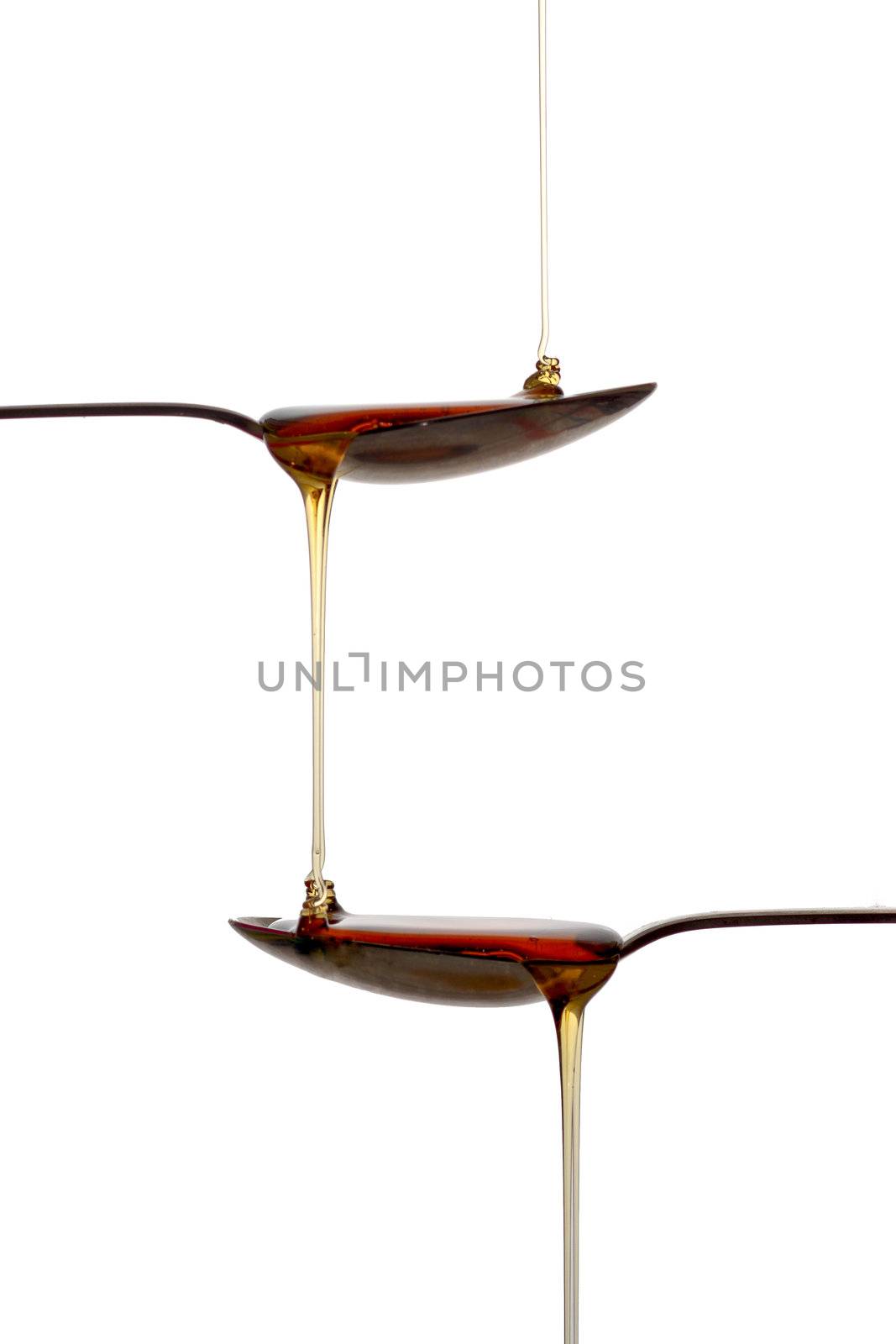 Spoons with syrup by lavsen