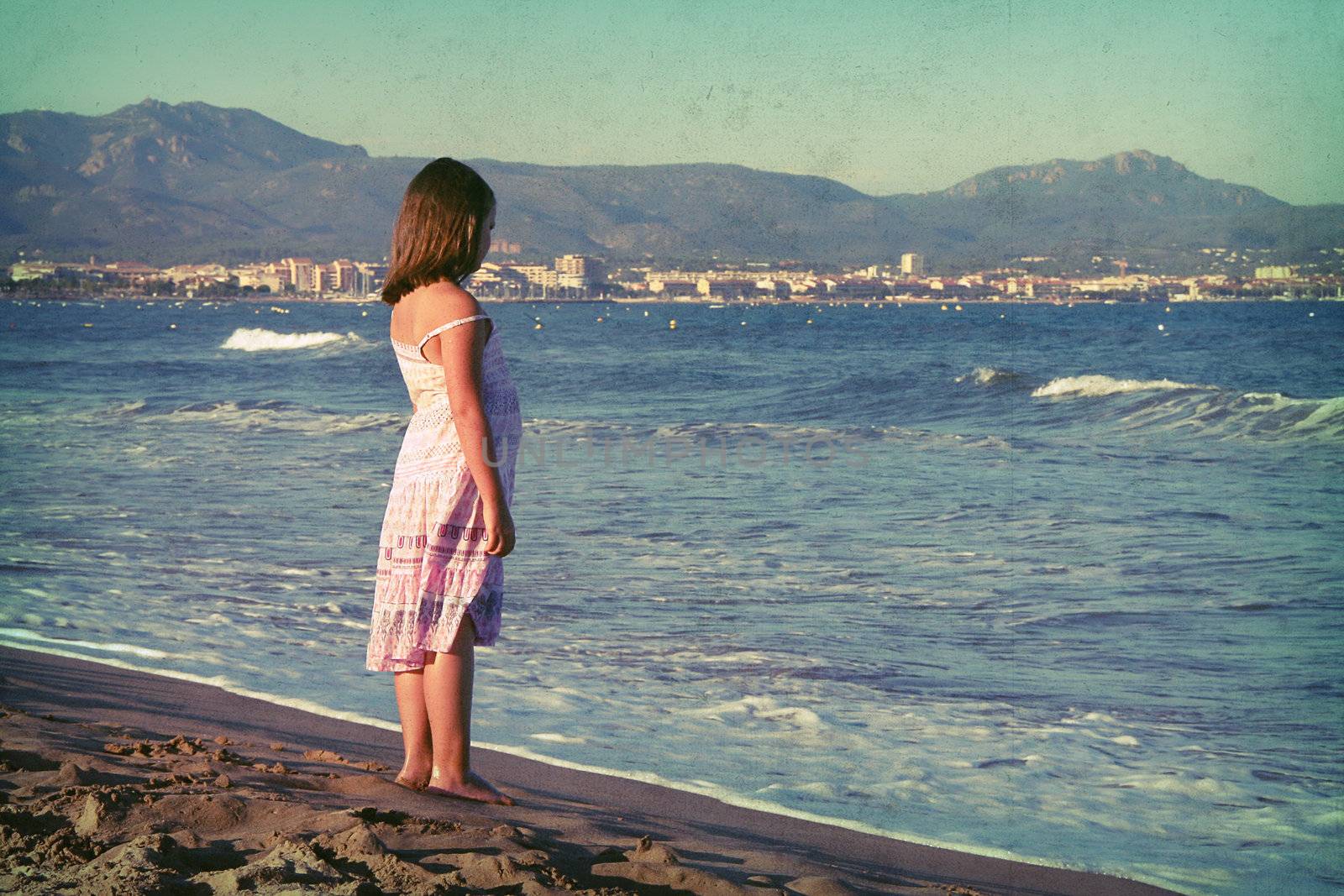 the little girl standing on the beach
