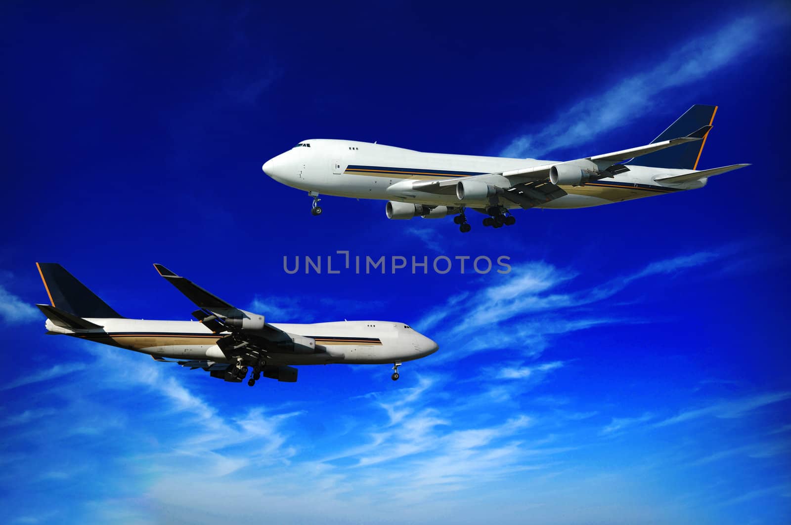 Two jumbo jets on a blue sky.