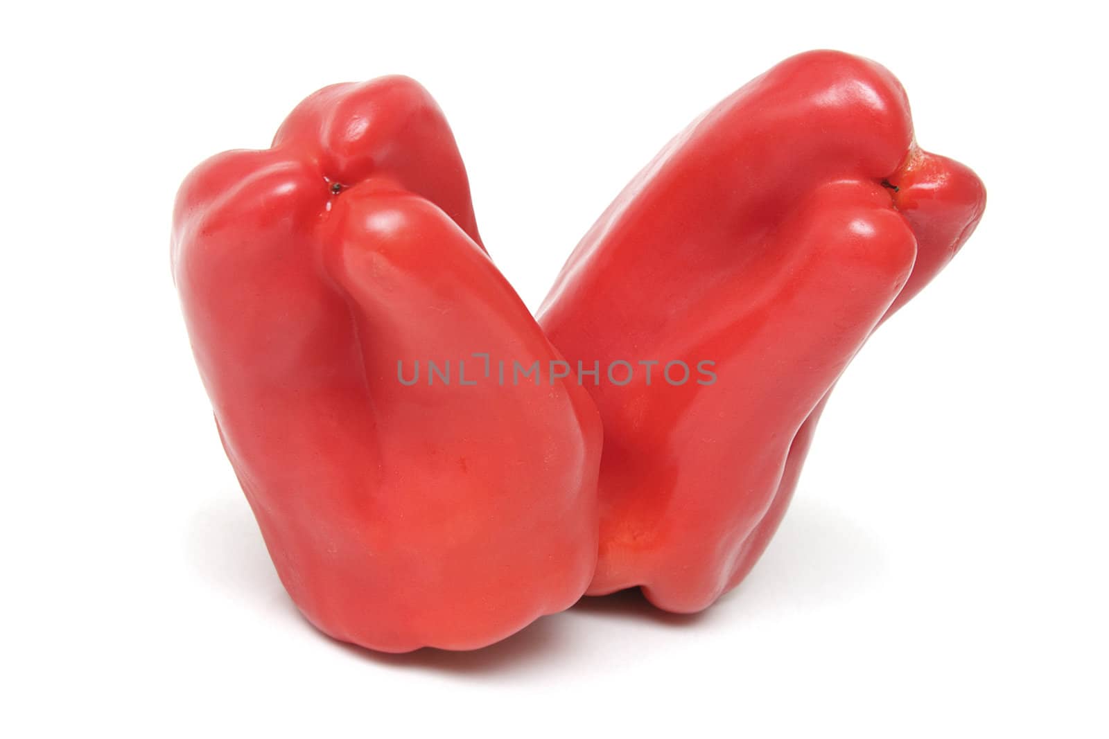 Two red peppers isolated on white background